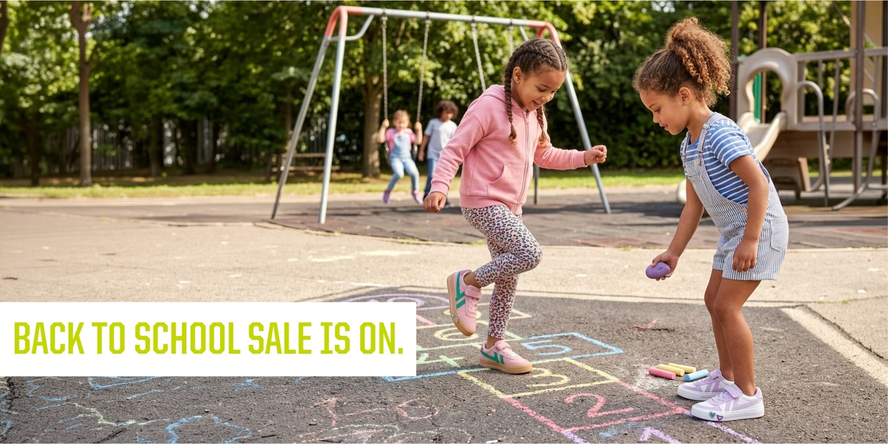 Two young girls playing hopscotch on a playground with chalk, with a swing set and trees in the background. A text banner at the bottom reads 'BACK TO SCHOOL SALE IS ON. contains-synthetic-performers